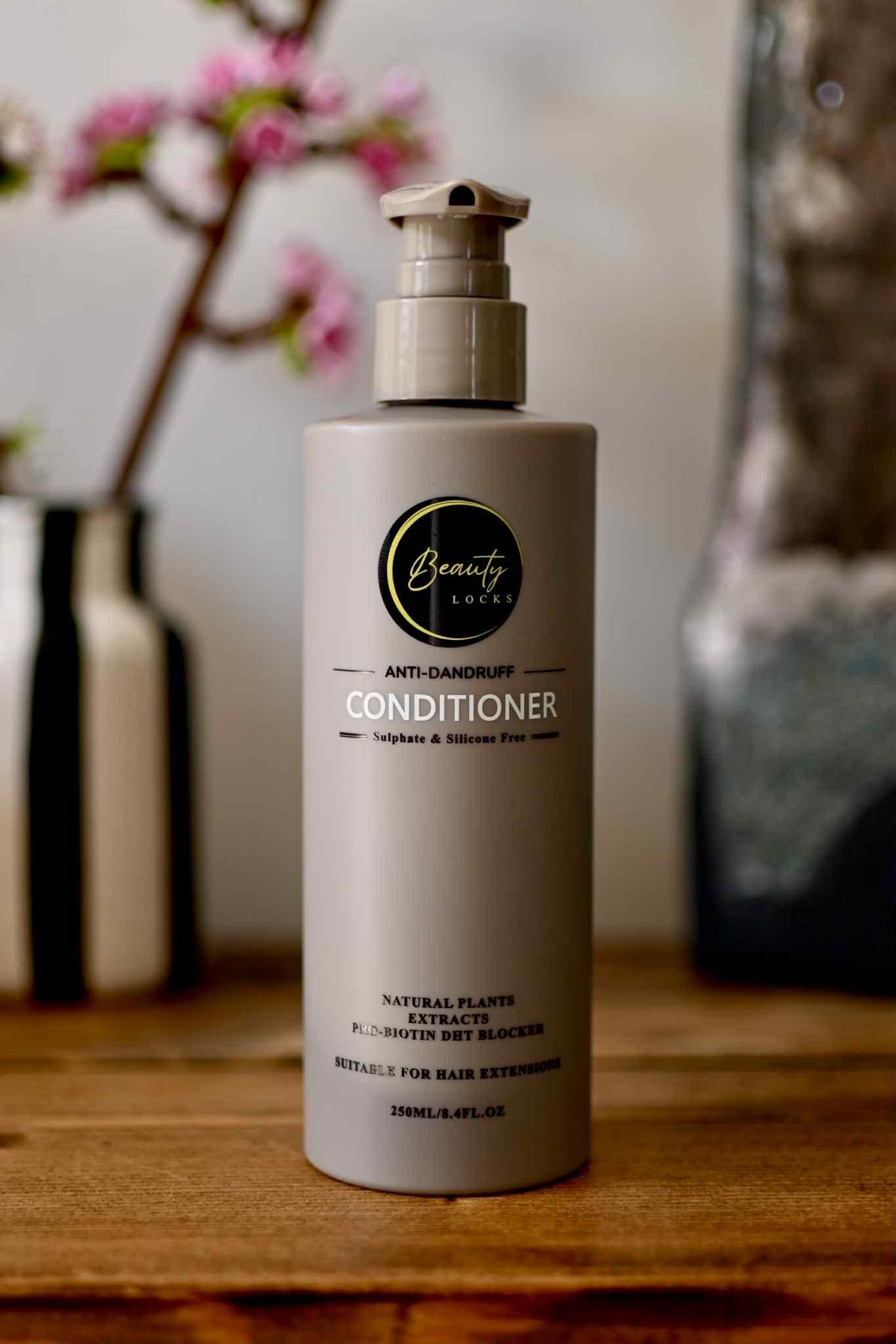 Brown conditioner bottle with brand logo on a wooden surface