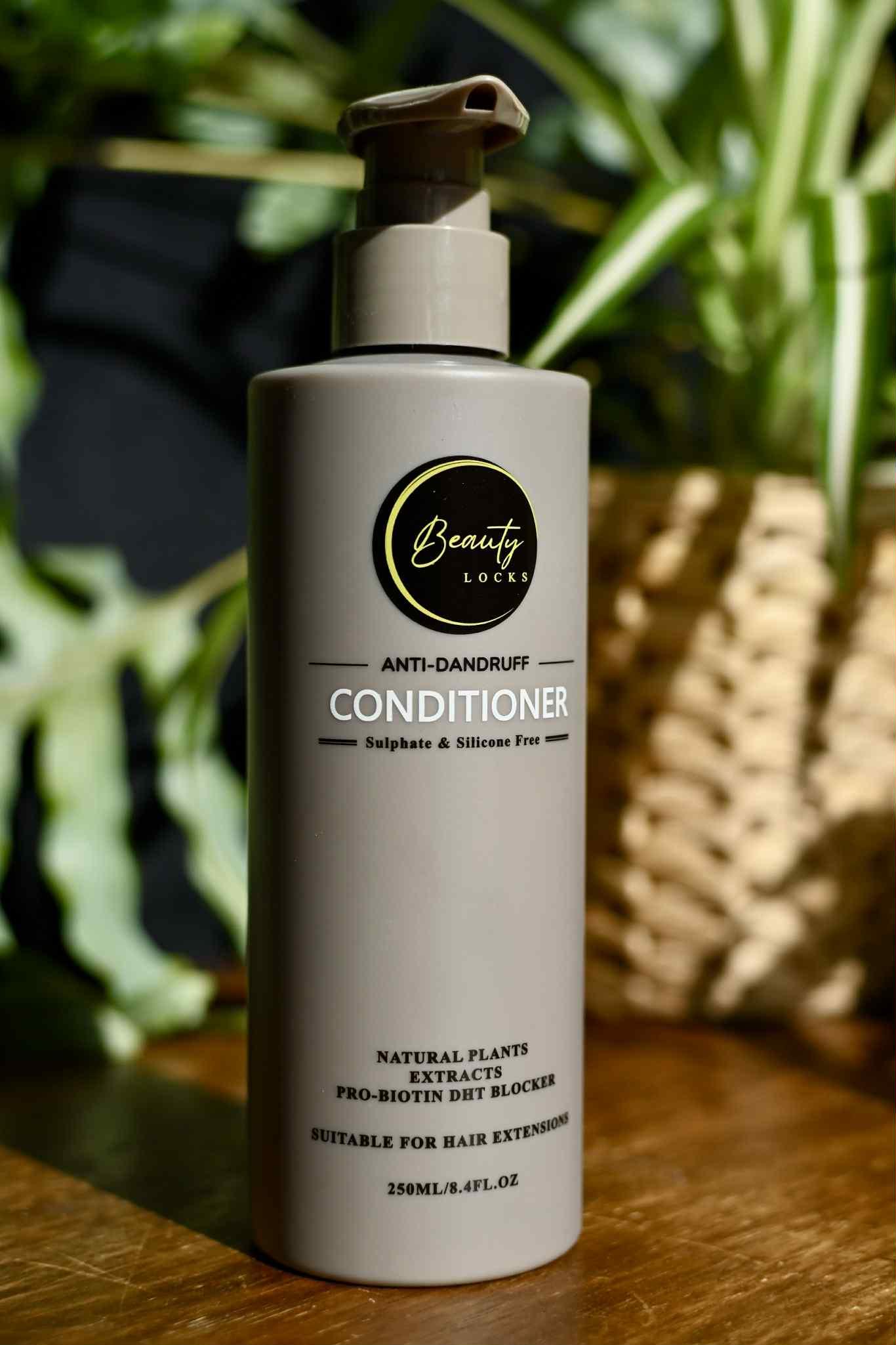 Brown conditioner bottle with pump on a wooden surface, greenery in the background