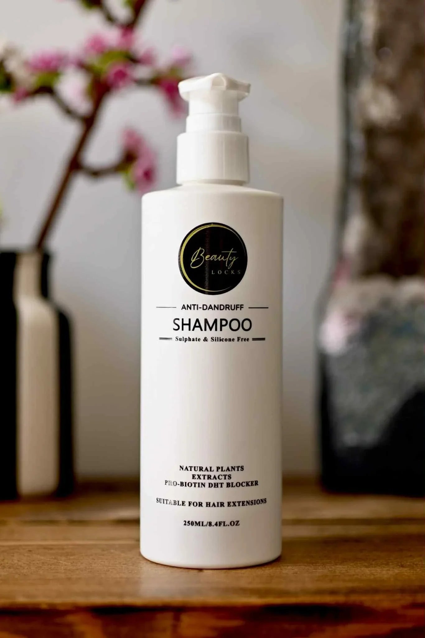 White shampoo bottle with text on a wooden surface